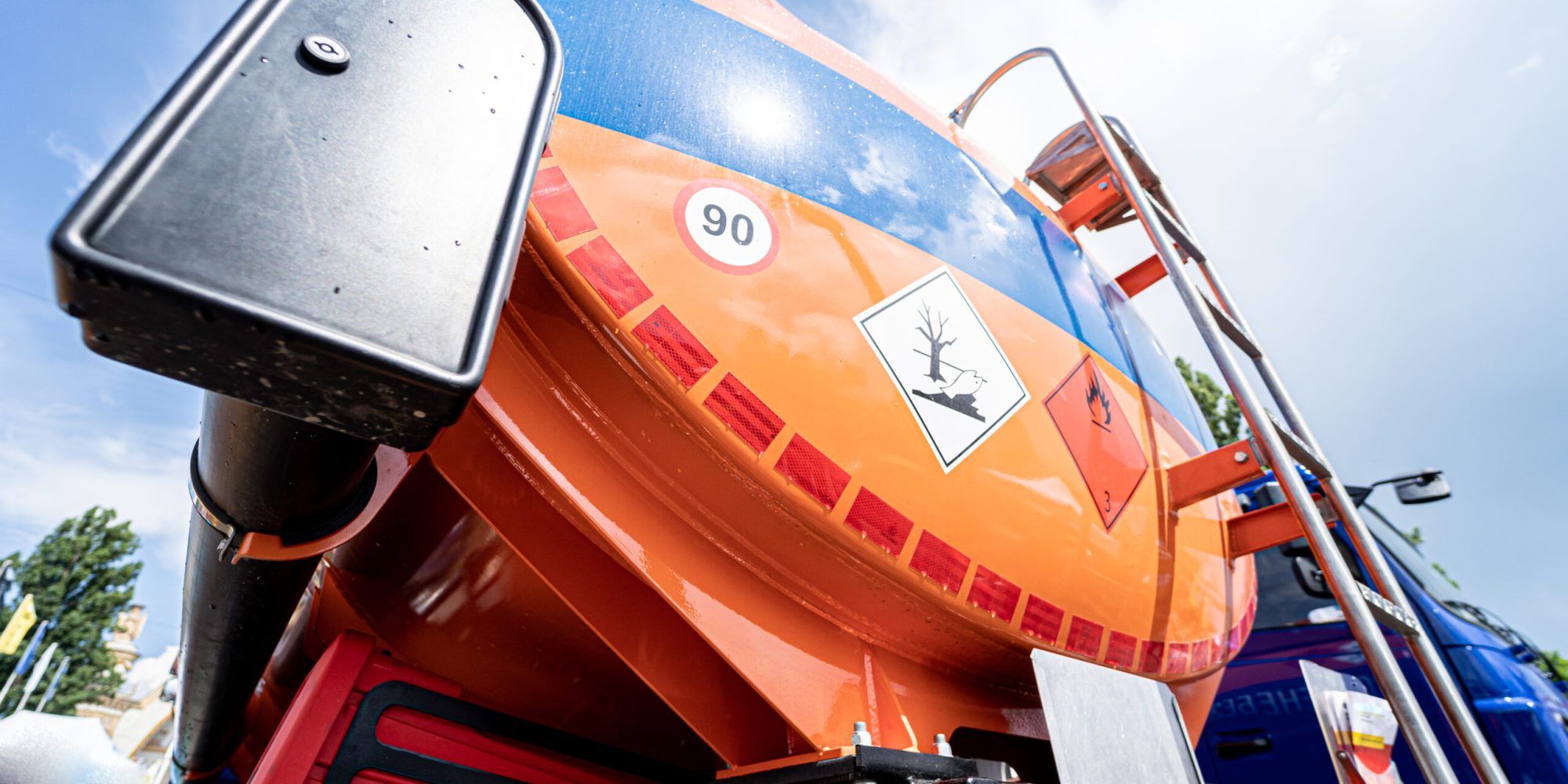 Big fuel tanker truck on the blue sky background.